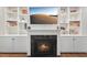 A cozy black marble fireplace with built-in shelves and a TV at 904 Coral Bell Dr, Wake Forest, NC 27587