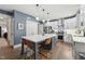 Modern kitchen featuring a large island, stainless steel appliances, and stylish pendant lighting, perfect for entertaining at 904 Coral Bell Dr, Wake Forest, NC 27587