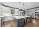 Modern kitchen featuring a large island, stainless steel appliances, and stylish pendant lighting, perfect for entertaining at 904 Coral Bell Dr, Wake Forest, NC 27587