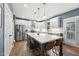 Modern kitchen with stainless steel appliances, spacious island, white cabinetry, and hardwood floors, perfect for cooking at 904 Coral Bell Dr, Wake Forest, NC 27587