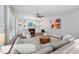 Bright living room features a fireplace, custom built-ins, ceiling fan and hardwood floors at 904 Coral Bell Dr, Wake Forest, NC 27587