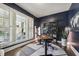 Well-lit home office with dark blue walls and hardwood floors at 904 Coral Bell Dr, Wake Forest, NC 27587