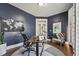 Well-lit home office with dark blue walls and hardwood floors at 904 Coral Bell Dr, Wake Forest, NC 27587