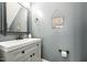 Charming powder room with mirror and framed art, enhanced by muted gray walls at 904 Coral Bell Dr, Wake Forest, NC 27587