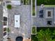 Aerial view of a backyard with patio, fire pit, lush lawn, landscape design, and outdoor dining area at 1001 Manchester Dr, Raleigh, NC 27609