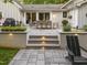 Inviting back patio with outdoor dining and comfortable seating arrangement and landscape design at 1001 Manchester Dr, Raleigh, NC 27609