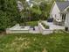 Large backyard featuring a fire pit, dining area, patio, and lawn, and landscape design at 1001 Manchester Dr, Raleigh, NC 27609