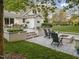 Backyard view featuring dining area, firepit, and well-kept lawn at 1001 Manchester Dr, Raleigh, NC 27609