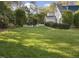 Large, well-maintained backyard lawn with patio and fire pit area at 1001 Manchester Dr, Raleigh, NC 27609