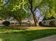 Spacious backyard featuring mature trees and a lush green lawn, and home's exterior at 1001 Manchester Dr, Raleigh, NC 27609