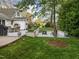 Expansive backyard with a patio, fire pit, outdoor dining area, and manicured lawn at 1001 Manchester Dr, Raleigh, NC 27609