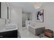 Bathroom with a large soaking tub, walk-in shower, and double sink vanity at 1001 Manchester Dr, Raleigh, NC 27609