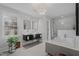 Elegant bathroom with double vanity, soaking tub, walk-in shower and statement lighting at 1001 Manchester Dr, Raleigh, NC 27609