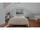 Cozy bedroom features a large window, wood floors, and a neutral color palette at 1001 Manchester Dr, Raleigh, NC 27609