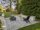 Cozy fire pit area with outdoor seating, landscape design, and patio at 1001 Manchester Dr, Raleigh, NC 27609