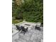 Outdoor fire pit area with seating, landscape design, and a brick patio at 1001 Manchester Dr, Raleigh, NC 27609