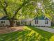 Charming home with beautiful lawn, flowering tree, and welcoming curb appeal at 1001 Manchester Dr, Raleigh, NC 27609