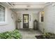 Charming front porch with brick walls, decorative plants, and a stylish front door at 1001 Manchester Dr, Raleigh, NC 27609