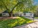 Beautiful home with a well-manicured lawn, mature shade tree, and quaint curb appeal exudes charm and comfort at 1001 Manchester Dr, Raleigh, NC 27609