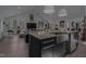 Bright kitchen with stainless steel appliances, an island sink, and an open-concept design at 1001 Manchester Dr, Raleigh, NC 27609