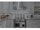 Gourmet kitchen featuring a stainless steel range hood, granite countertops, and custom cabinets at 1001 Manchester Dr, Raleigh, NC 27609