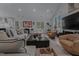 Open-concept living room featuring a large sectional, stylish decor, and plenty of natural light at 1001 Manchester Dr, Raleigh, NC 27609