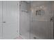 Modern tiled shower featuring a glass door, built-in niche, and sleek fixtures at 1001 Manchester Dr, Raleigh, NC 27609
