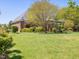 Lovely backyard with a covered porch and a well-manicured lawn at 1008 Maduro Ct, Zebulon, NC 27597