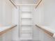 A walk-in closet features lots of shelving and hanging rods at 1008 Maduro Ct, Zebulon, NC 27597