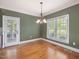 Charming dining room featuring a stylish chandelier, natural light, and hardwood flooring for a cozy and inviting atmosphere at 1008 Maduro Ct, Zebulon, NC 27597