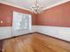 Formal dining room features a large window, chandelier, and decorative trim throughout the room at 1008 Maduro Ct, Zebulon, NC 27597