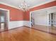 Spacious dining room features detailed trim, a chandelier, and an open layout into the foyer with hardwood floors at 1008 Maduro Ct, Zebulon, NC 27597