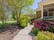 A sidewalk leads to the home which features beautiful landscaping and a screened porch at 1008 Maduro Ct, Zebulon, NC 27597