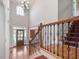 Elegant foyer featuring hardwood floors and a staircase with decorative iron railings at 1008 Maduro Ct, Zebulon, NC 27597