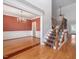 Elegant foyer with hardwood floors, staircase, and chandelier, adjacent to a formal dining room with detailed trim at 1008 Maduro Ct, Zebulon, NC 27597