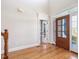 Bright foyer with hardwood floors and a view of the front door and adjacent rooms at 1008 Maduro Ct, Zebulon, NC 27597