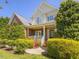 Charming two-story home with a welcoming front porch and lush landscaping at 1008 Maduro Ct, Zebulon, NC 27597