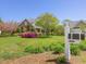 Well-manicured front yard with vibrant flowers and a classic mailbox at 1008 Maduro Ct, Zebulon, NC 27597