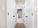 A hallway leads to a bathroom with a shower and a bathtub at 1008 Maduro Ct, Zebulon, NC 27597