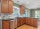 The kitchen shows wooden cabinetry, stainless appliances, and a granite countertop at 1008 Maduro Ct, Zebulon, NC 27597