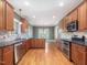 Open-concept kitchen boasts stainless steel appliances, granite counters, and wood cabinetry at 1008 Maduro Ct, Zebulon, NC 27597