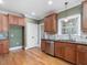 A kitchen features wooden floors, a window above the sink, and stainless steel appliances at 1008 Maduro Ct, Zebulon, NC 27597