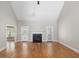 Vaulted living room with hardwood floors, fireplace, backyard access, and ample natural light at 1008 Maduro Ct, Zebulon, NC 27597