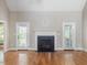 Bright living room with vaulted ceilings, fireplace, hardwood floors, backyard access, and ample natural light at 1008 Maduro Ct, Zebulon, NC 27597