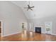 Bright living room with vaulted ceilings, fireplace, hardwood floors, and access to the backyard at 1008 Maduro Ct, Zebulon, NC 27597