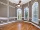 Elegant living room with hardwood floors, decorative wall trim, and large windows at 1008 Maduro Ct, Zebulon, NC 27597