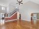 Bright open-concept living room with hardwood floors, staircase, and tall ceilings provide an airy and elegant living space at 1008 Maduro Ct, Zebulon, NC 27597