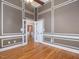 Spacious room with hardwood floors, detailed wall trim, and double doors leading to another room at 1008 Maduro Ct, Zebulon, NC 27597