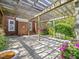 Charming covered patio with beautiful wood pergola, brick exterior, and mature landscaping provides a relaxing outdoor space at 1008 Maduro Ct, Zebulon, NC 27597