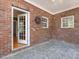 Charming brick patio with stone floors, providing a cozy outdoor space to enjoy the fresh air and relax with friends and Gathering at 1008 Maduro Ct, Zebulon, NC 27597